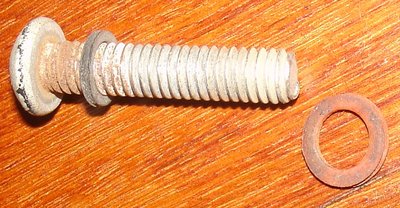 dash bolt from 25-4997 with original fiber washer and an earlier fiber washerr.JPG and 